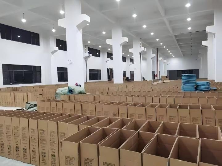 Cardboard cartons and packing materials arranged in the Inhekids warehouse.