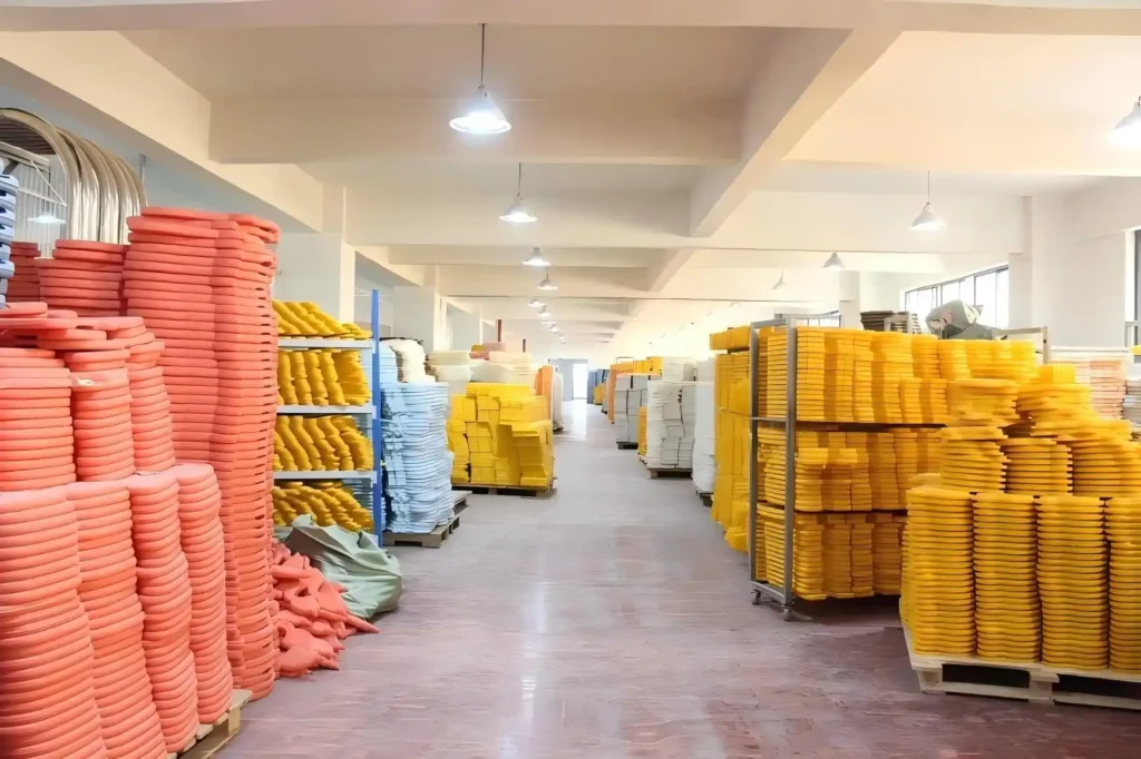 Stacks of finished molded plastic parts in the Inhekids production area.