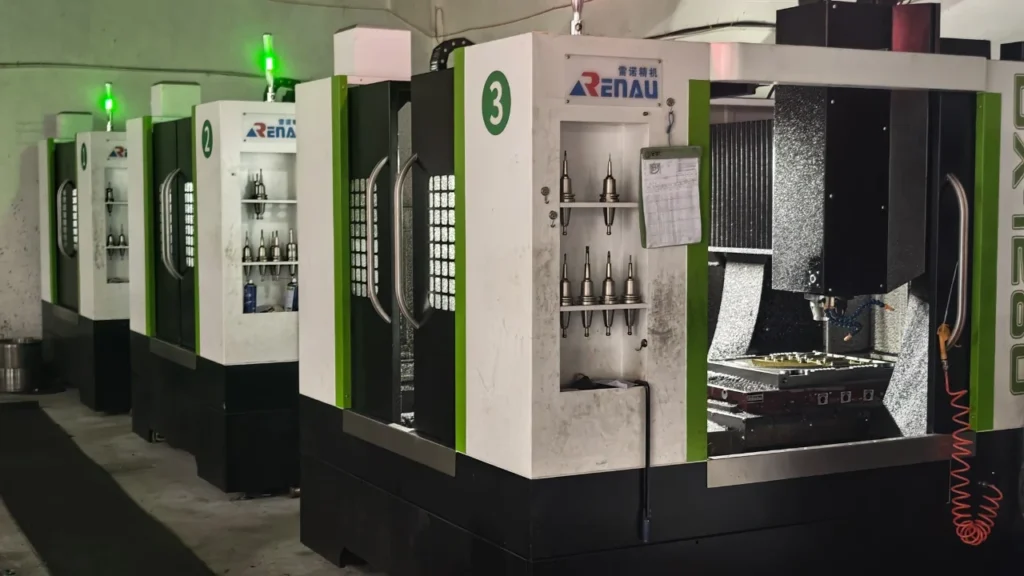 High-precision CNC milling machine with automatic tool changer in operation, carving complex metal steel components for custom plastic toy molds.