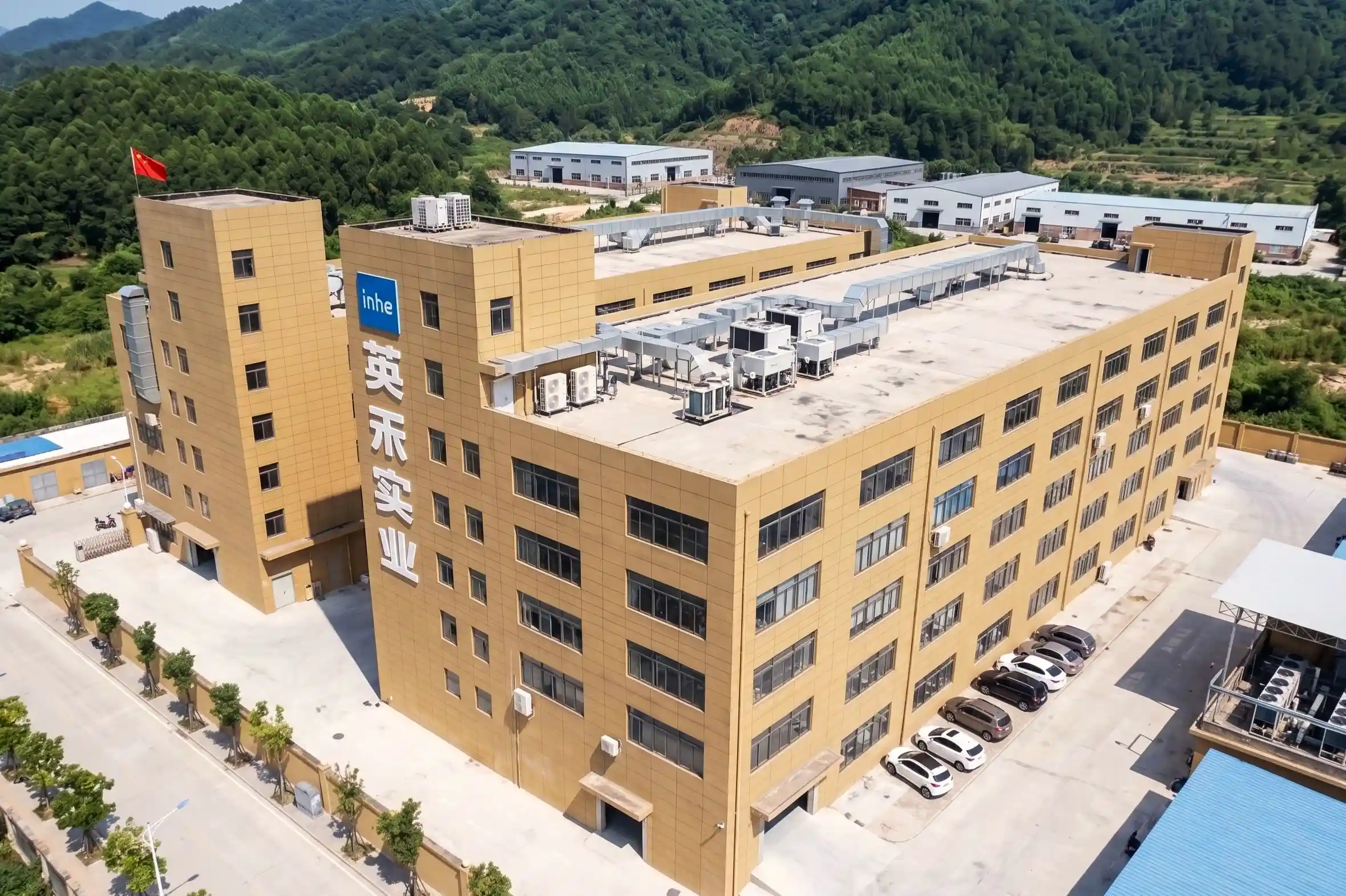 Aerial drone view of Zhejiang Inhe Industrial Co., Ltd. massive factory manufacturing facility and headquarters building in China.
