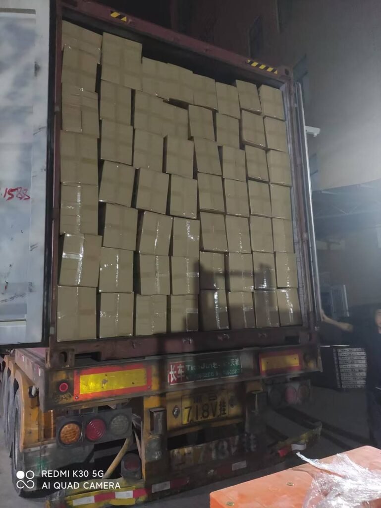Cartons for a children’s furniture order arranged inside an open shipping container.