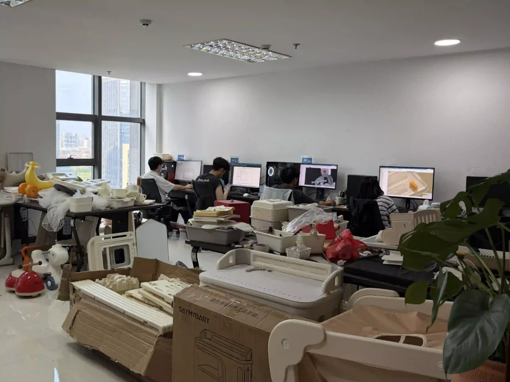 Our in-house R&D engineering team working on 3D CAD modeling, structural optimization, and physical sample testing for custom plastic kids furniture and toys.
