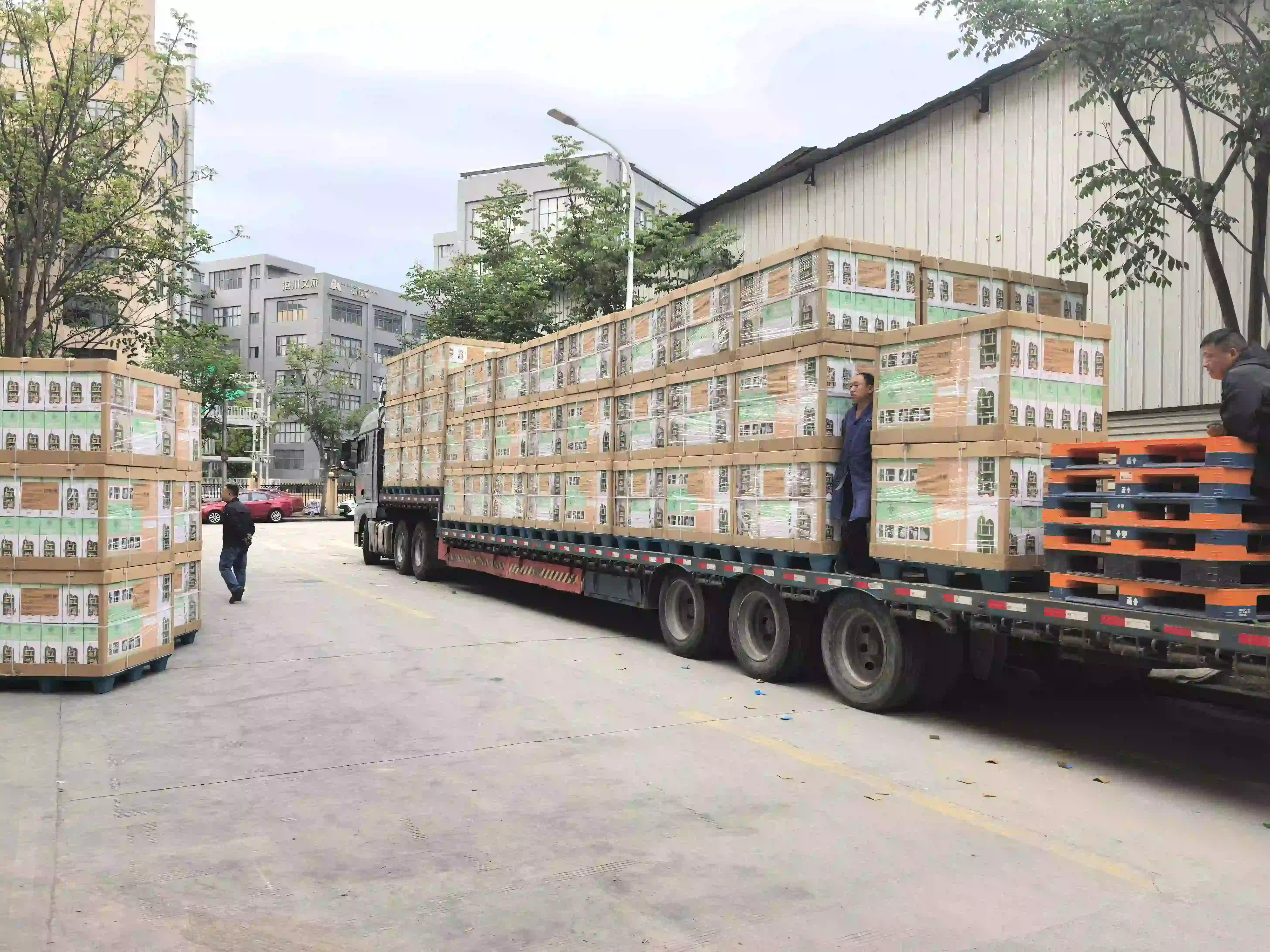 Personnel managing secure packaging and palletization protocols for a major children's storage cabinet export shipment.
