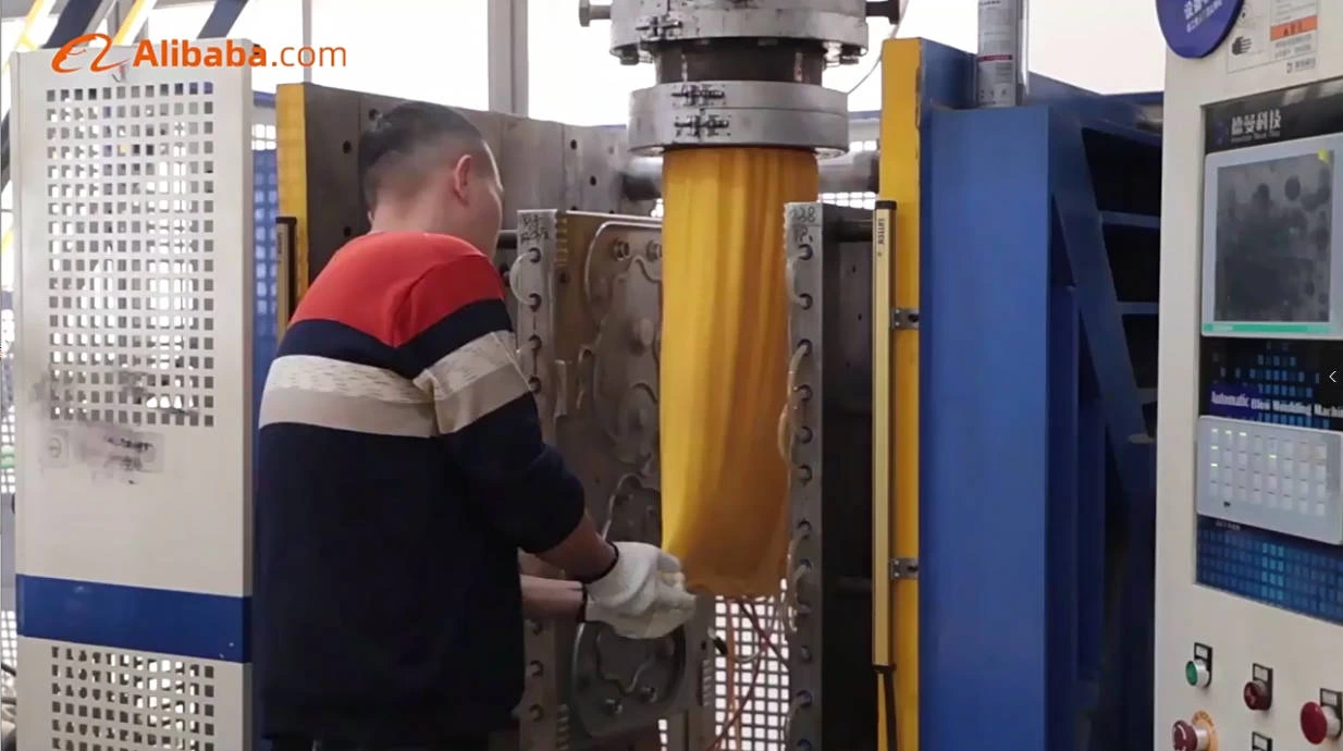 Worker operating a blow molding machine in the Inhekids production area.
